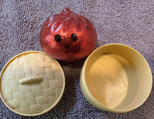 Recalled red Squishy Dumpling water bead toy next to its tan container, ABC Trading model 3655, CPSC recall October 2026