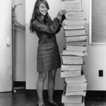 Margaret Hamilton beside Apollo program software printouts in 1969.