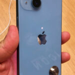 Photograph of an iPhone 14 hardware, showing a phone model with screen orientation controls
