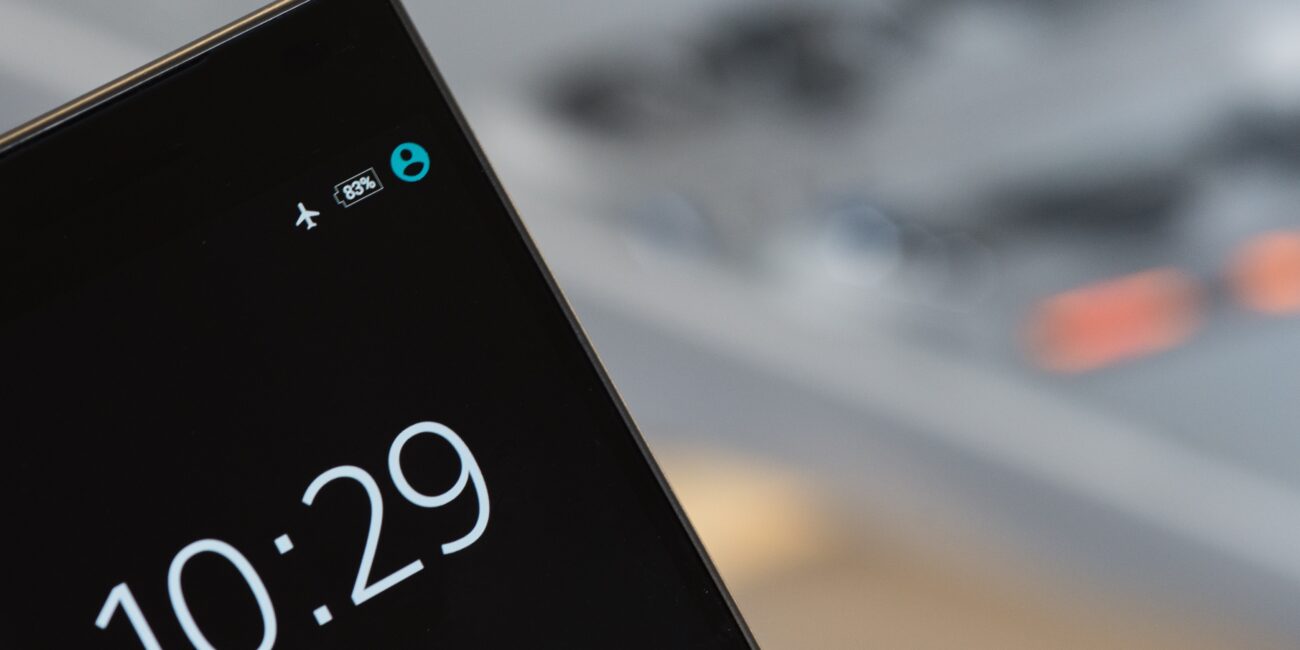 Close-up photograph of a smartphone display with an airplane mode indicator among its status icons