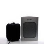 Real photograph of Apple AirPods earbuds with an Apple HomePod speaker
