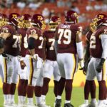 Washington Football Team offensive linemen line up before a snap against the Cincinnati Bengals in August 2021