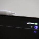Apple Pencil resting on the magnetic edge of an iPad Pro during pairing