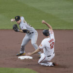 Pittsburgh Pirates infielder Max Moroff receiving a throw to force a Baltimore Orioles runner out at second base