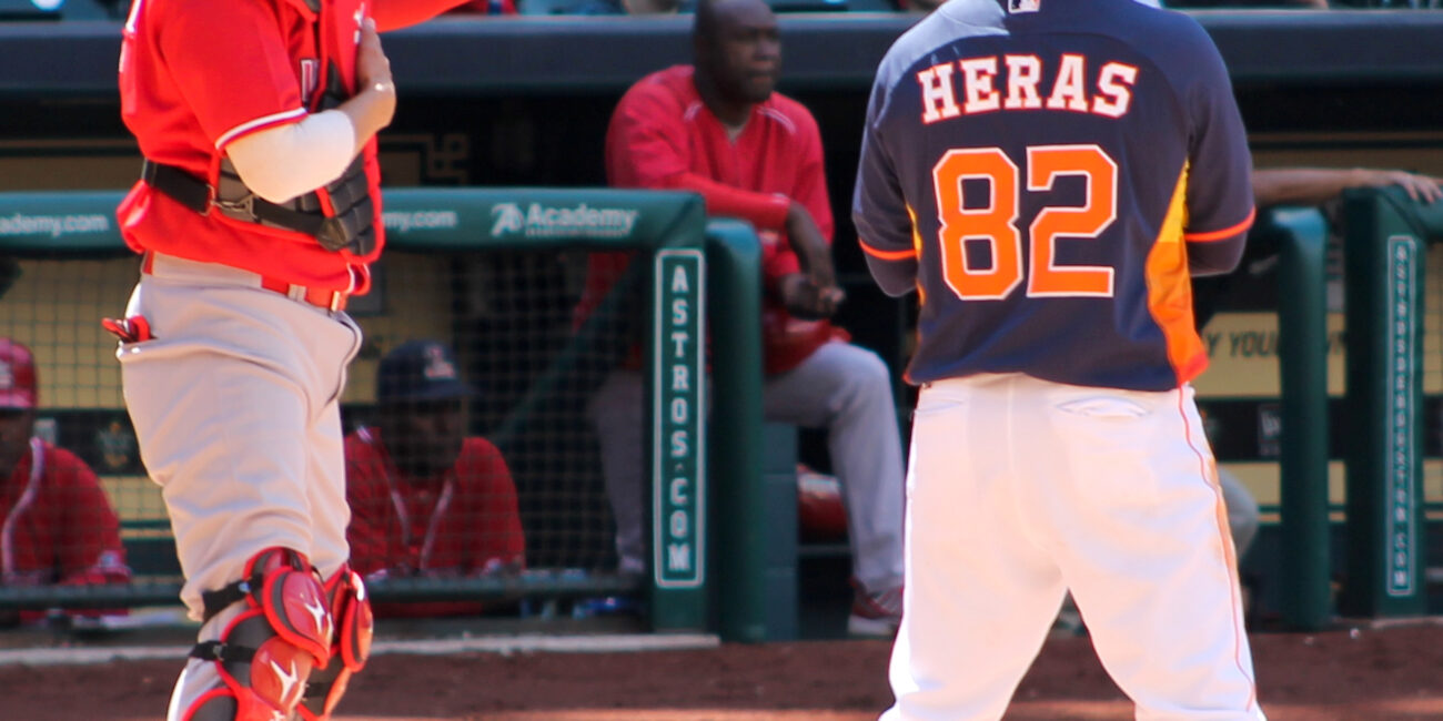 A catcher raises his glove to signal an intentional walk during a 2014 baseball game, before MLB introduced automatic intentional walks