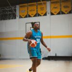 Basketball player controlling a dribble during practice on a court