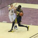 Tim Hardaway Jr is fouled while advancing on a fast break in a Michigan college basketball game