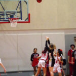Basketball player making a jump shot during a game