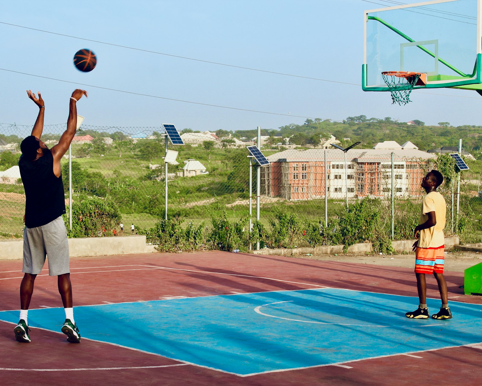 Basketball player practicing a shot on an indoor court