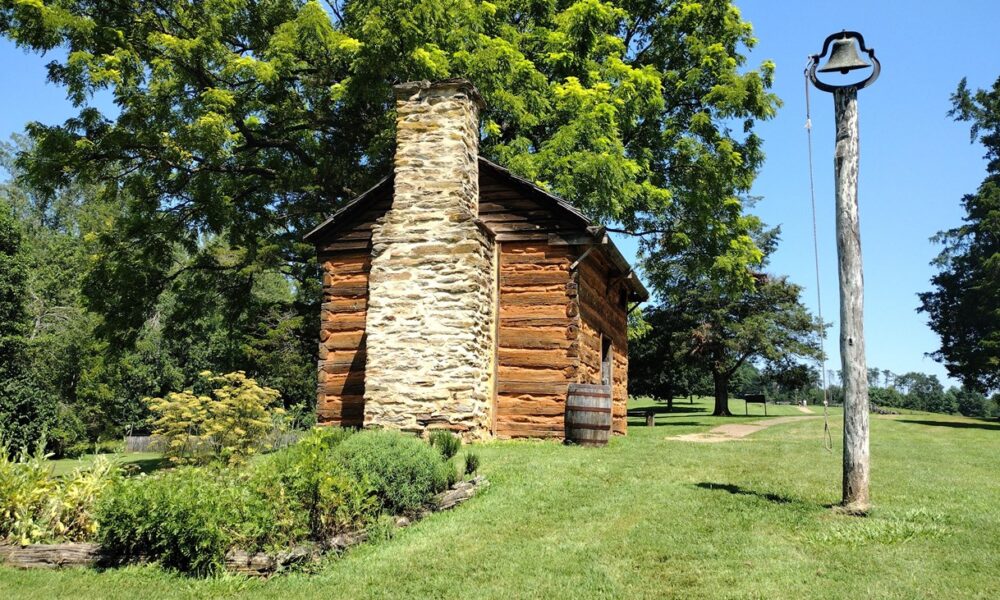 Reconstructed kitchen cabin, stone chimney and bell at Booker T. Washington National Monument in Virginia