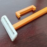 Disposable cartridge-style razor with protective plastic cover for TSA carry-on packing guide