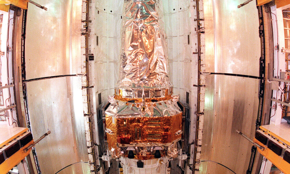 Real Chandra X-ray Observatory spacecraft with upper-stage hardware inside Space Shuttle Columbia payload bay before July 1999 launch