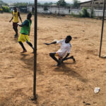 Football goalkeeper saving an incoming shot during a match, illustrating the aim of a clean sheet