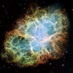 Real Hubble Space Telescope image of Crab Nebula M1 supernova remnant with glowing filament shell and central pulsar region