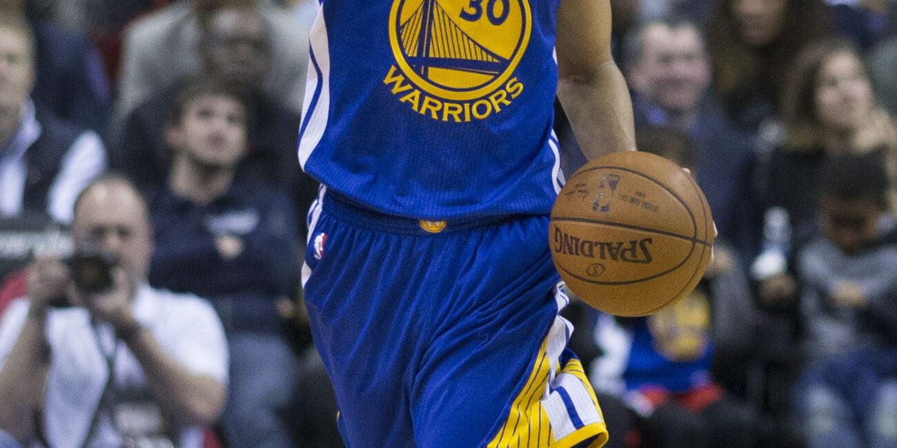 Stephen Curry controlling the basketball while dribbling during an NBA game in 2016