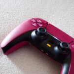 Red and black PlayStation 5 DualSense controller ready to pair by Bluetooth with an Android phone