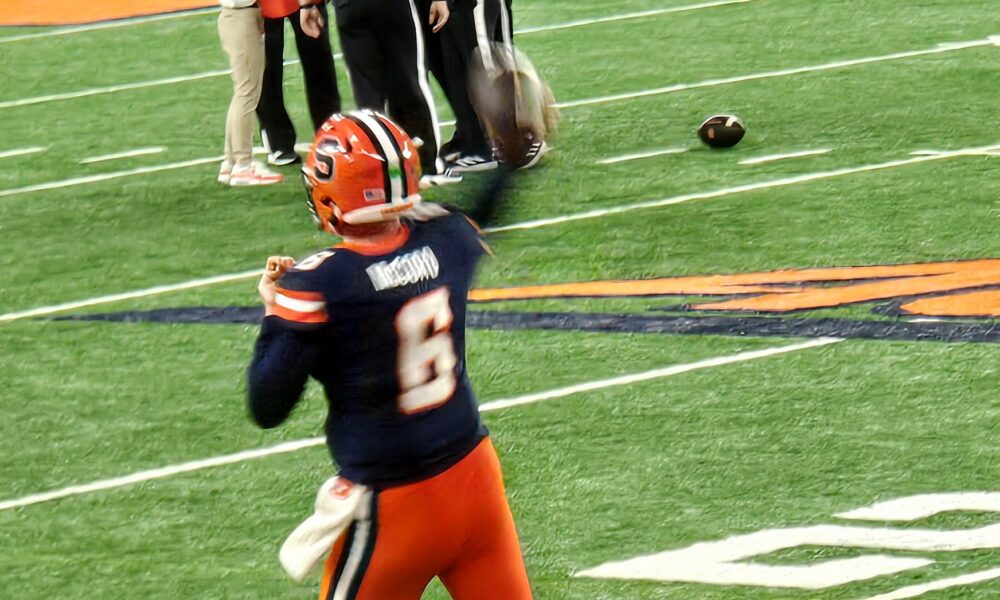 College quarterback Kyle McCord holding the football before a practice pass
