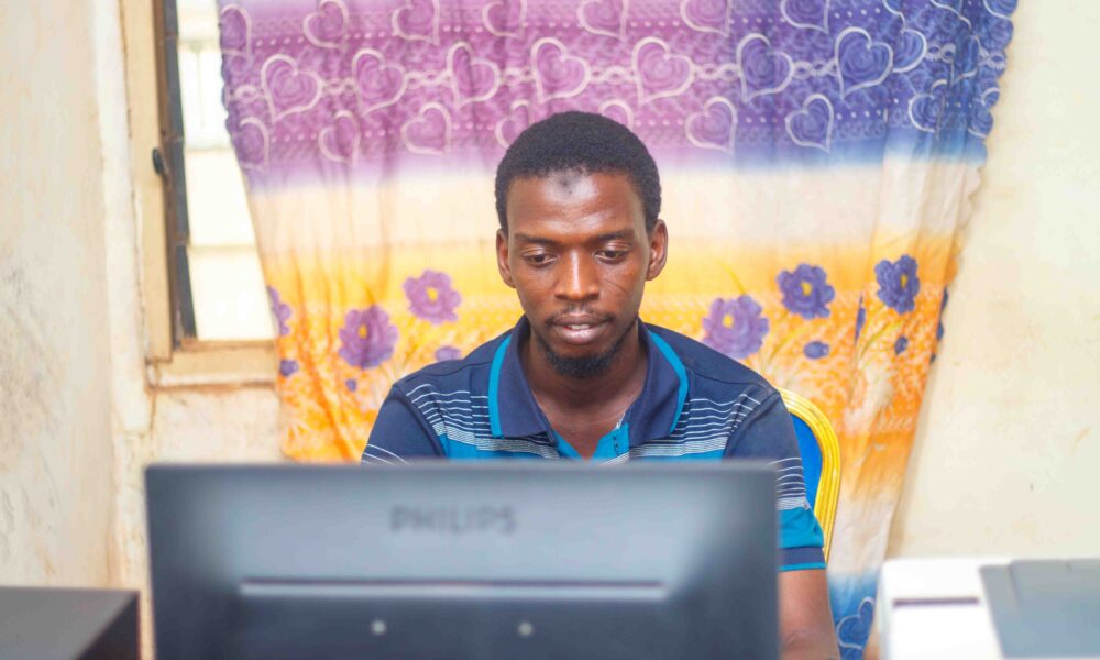 Person typing on a laptop during a computer literacy session, illustrating changing a Google Account password