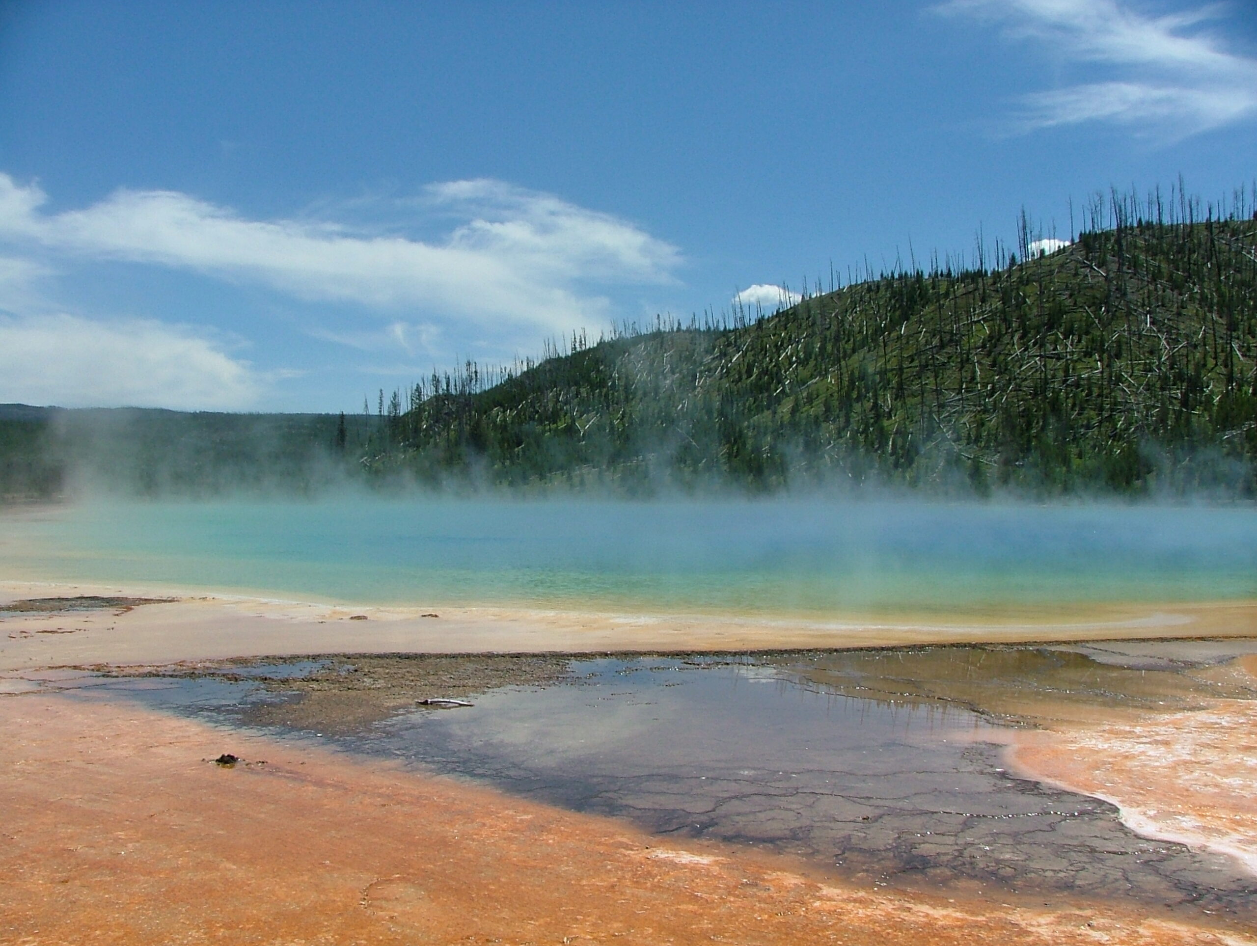 Real public-domain 2006 ground-level photograph of Yellowstone Grand Prismatic Spring thermal water and mineral colored margins by Jan Kronsell
