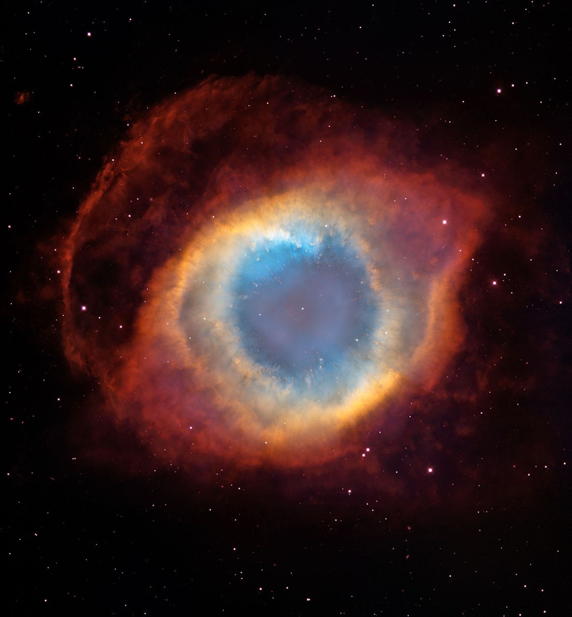 Genuine Hubble and Cerro Tololo composite showing the entire Helix Nebula as a blue central eye encircled by yellow and reddish gas