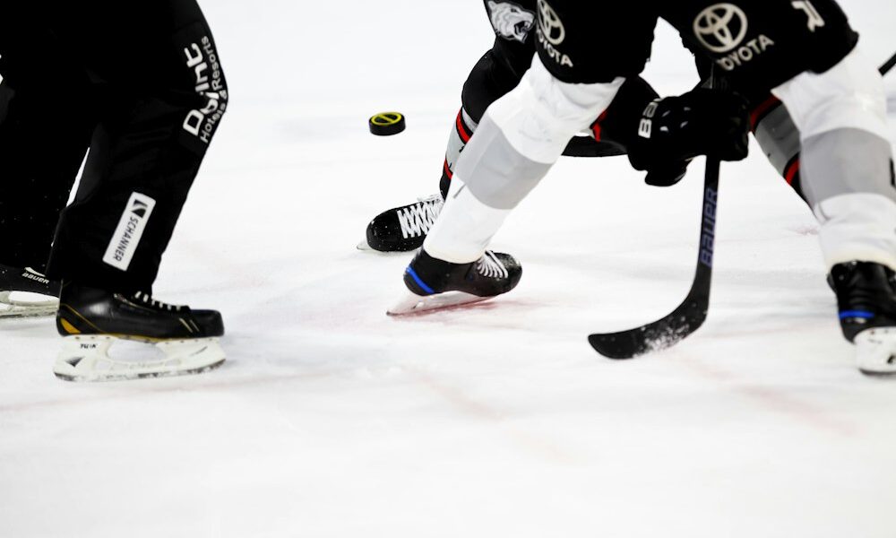 Ice hockey players competing on an indoor rink, illustrating the icing rule