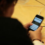 Physical iPhone with on-screen keyboard visible