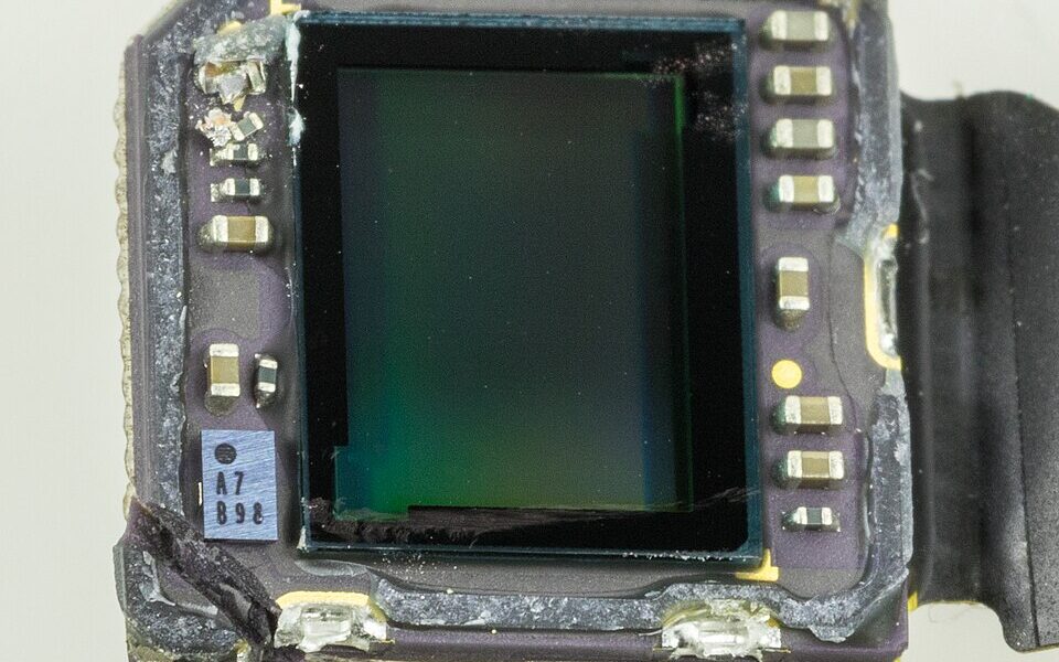 Close-up photo of an iPhone 6s rear camera module illustrating the photography format topic