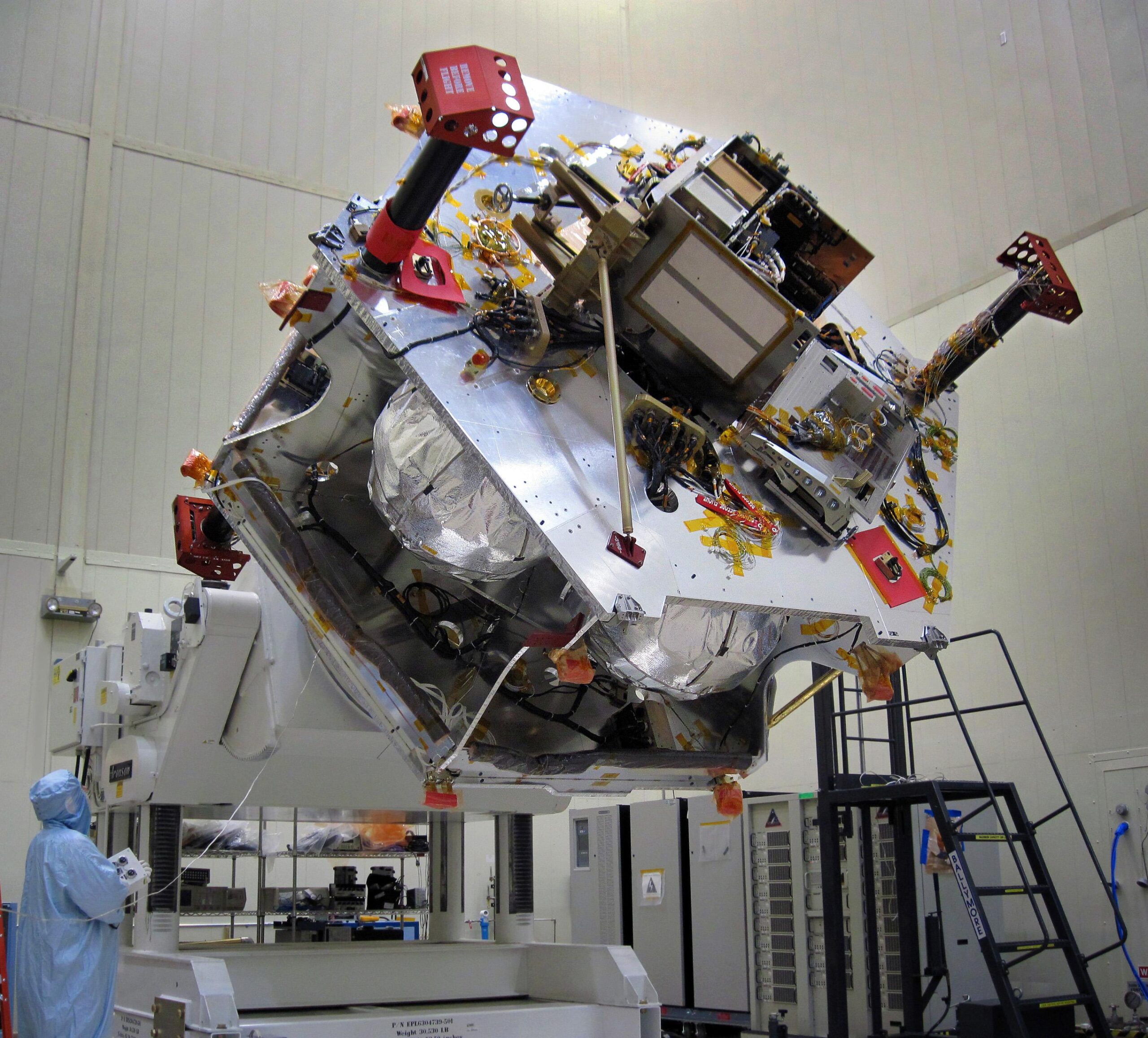 Real Juno spacecraft partially assembled on a rotation fixture in a Denver cleanroom in June 2010