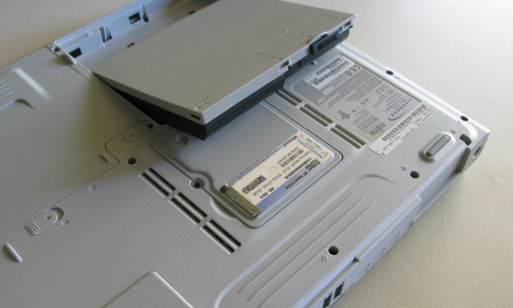 Real laptop computer with a removable battery beside the chassis