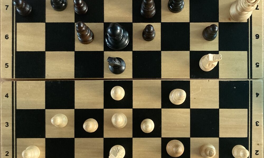 Overhead photograph of a checkmate position arising from a London System chess game