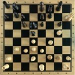Overhead photograph of a checkmate position arising from a London System chess game