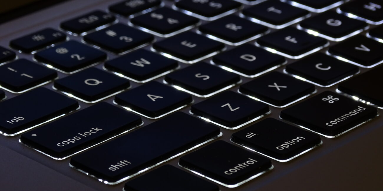 Real photograph of MacBook Air keyboard showing Command, Option, Control and Shift keys for macOS shortcuts