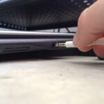 Headphone or microphone audio jack plugged into a laptop computer