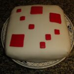 Real photograph of someone making a Minecraft-inspired square cake, illustrating the Minecraft cake crafting recipe