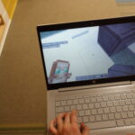 School student playing Minecraft on a monitor