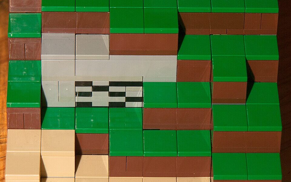 How to Make a Saddle in Minecraft (2026): Recipe, Uses and Old Versions Photograph of a LEGO Minecraft block-built scene; illustrative image for the Minecraft saddle crafting guide