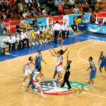 Two basketball players jump for the opening tip during the 2009 EuroBasket semifinal