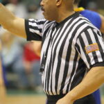 Basketball referee officiating a game illustrating NBA technical foul rules and penalties