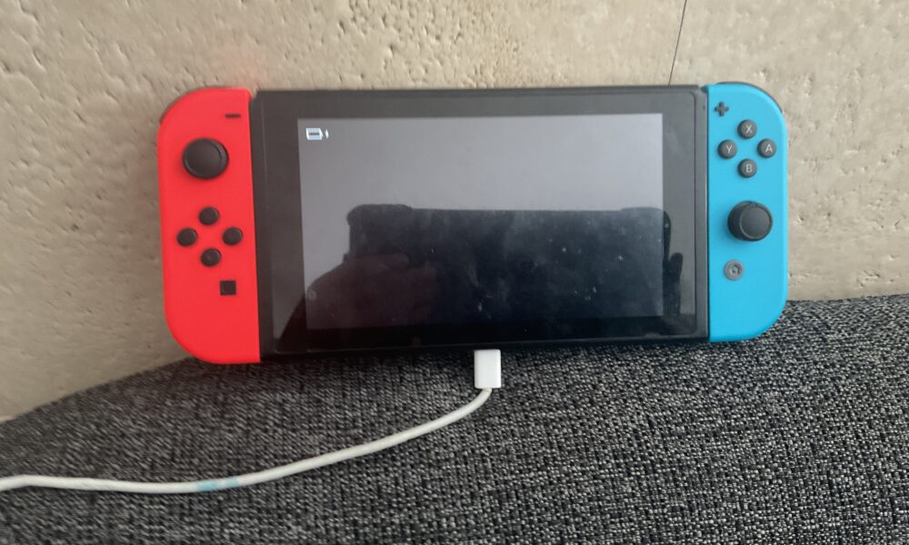 Nintendo Switch handheld gaming console photographed for charging troubleshooting