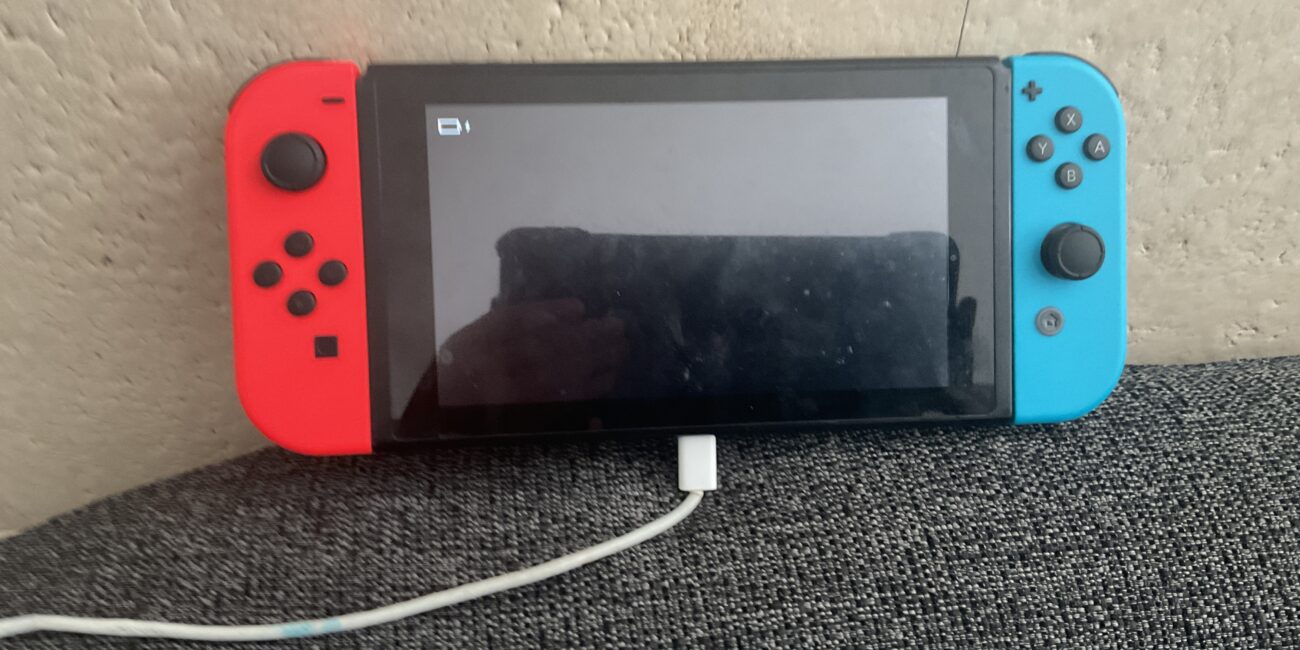 Nintendo Switch handheld gaming console photographed for charging troubleshooting