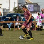 Soccer player dribbling the ball during a match, illustrating the nutmeg skill
