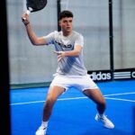 Padel player Fran Guerrero playing a shot on court
