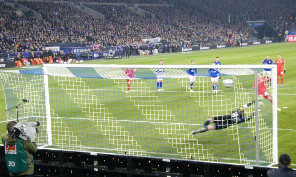 Marcus Ingvartsen taking a soccer penalty kick against Schalke goalkeeper Alexander Nübel during a match