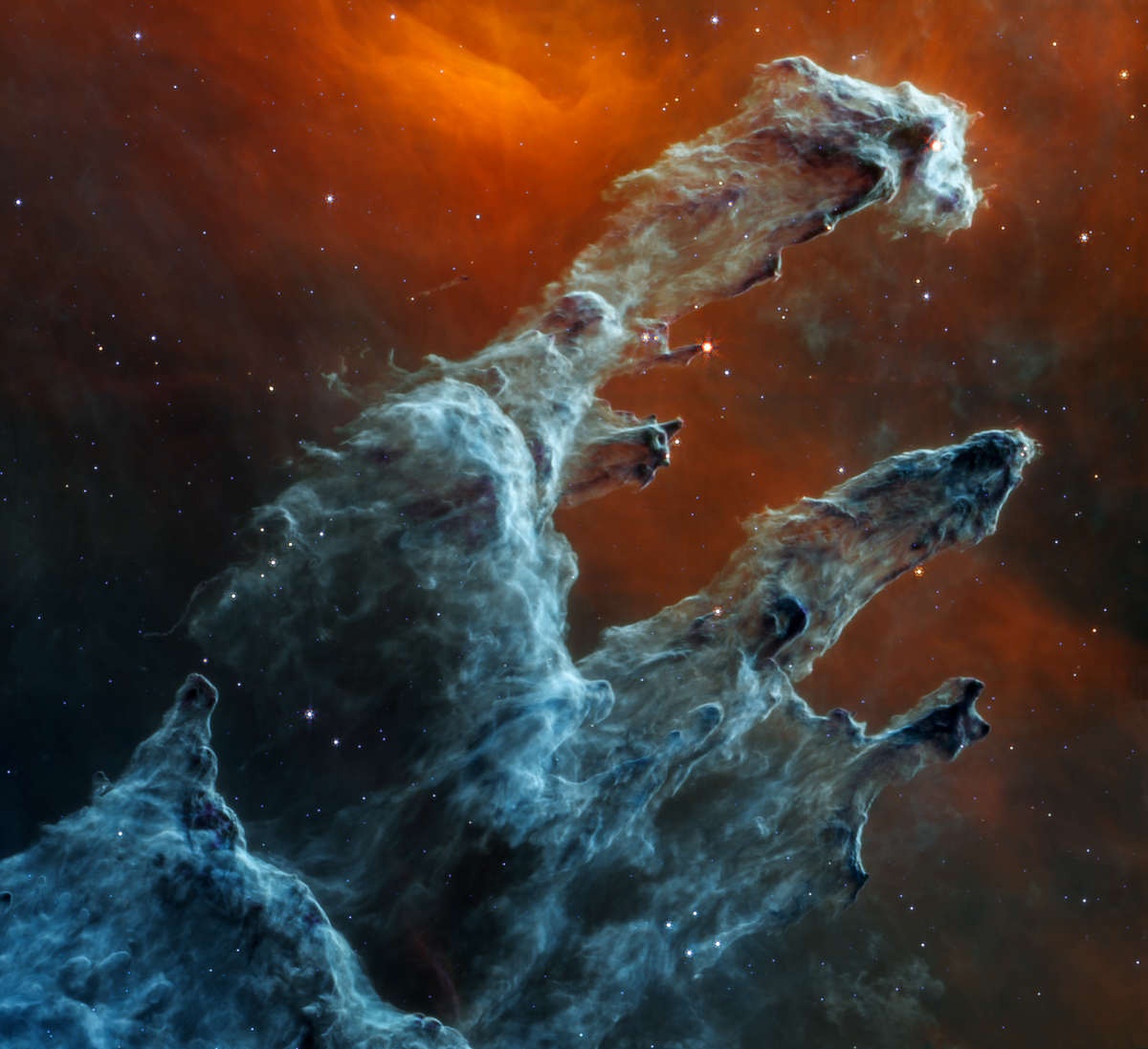 Actual separate 2022 NASA Webb MIRI mid-infrared image of the Pillars of Creation with gray-blue cosmic dust and less visible stars