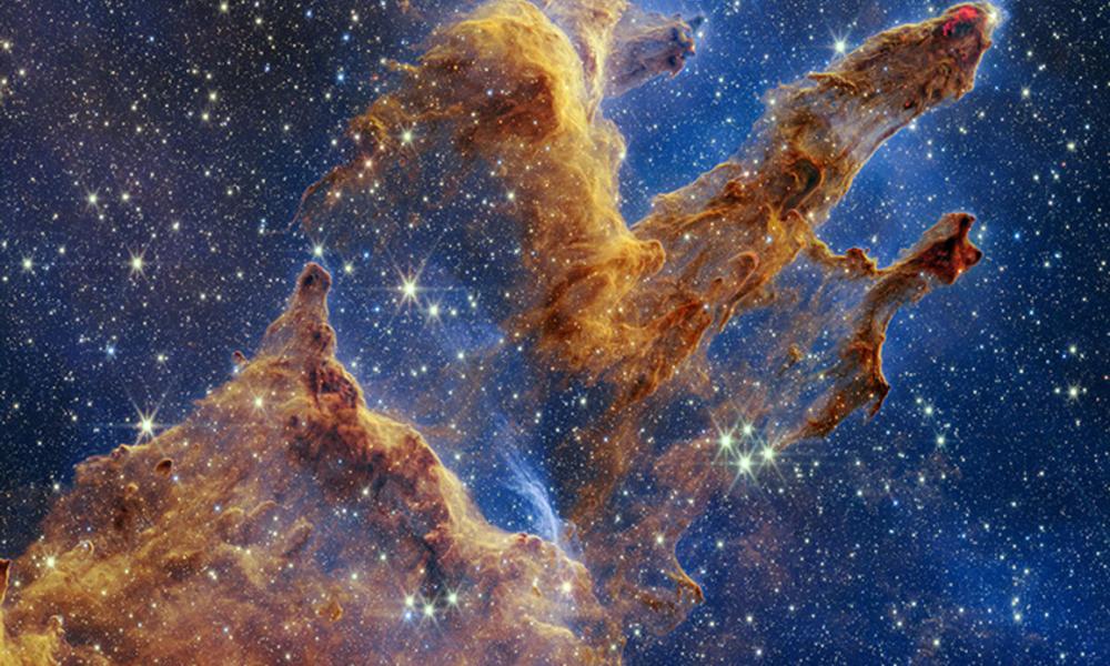 Real NASA James Webb telescope NIRCam infrared photograph of the Pillars of Creation in Eagle Nebula M16 with dusty columns and young stars