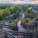 Wooden boardwalk and sandstone bluff at Pompeys Pillar National Monument in Montana