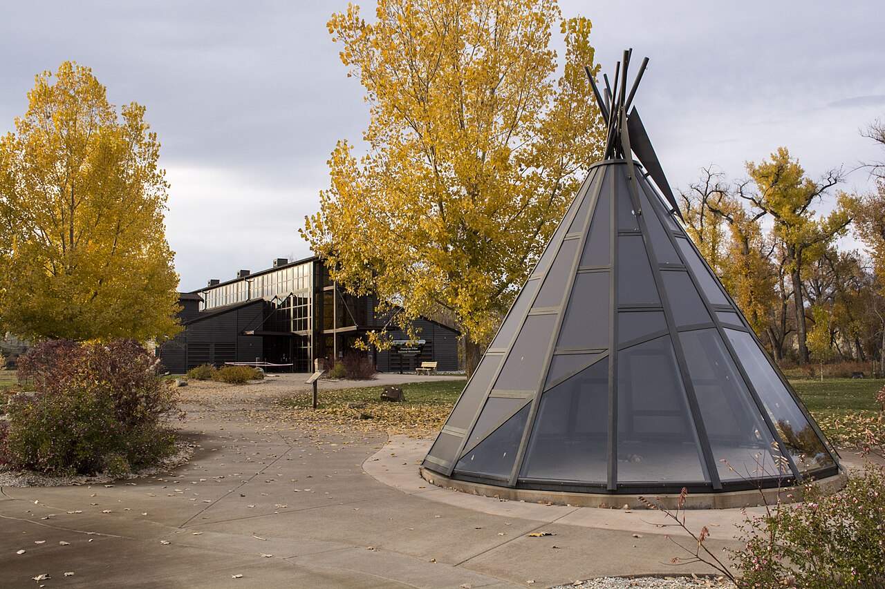 Glass tipi structure in front of Pompeys Pillar Interpretive Center in autumn