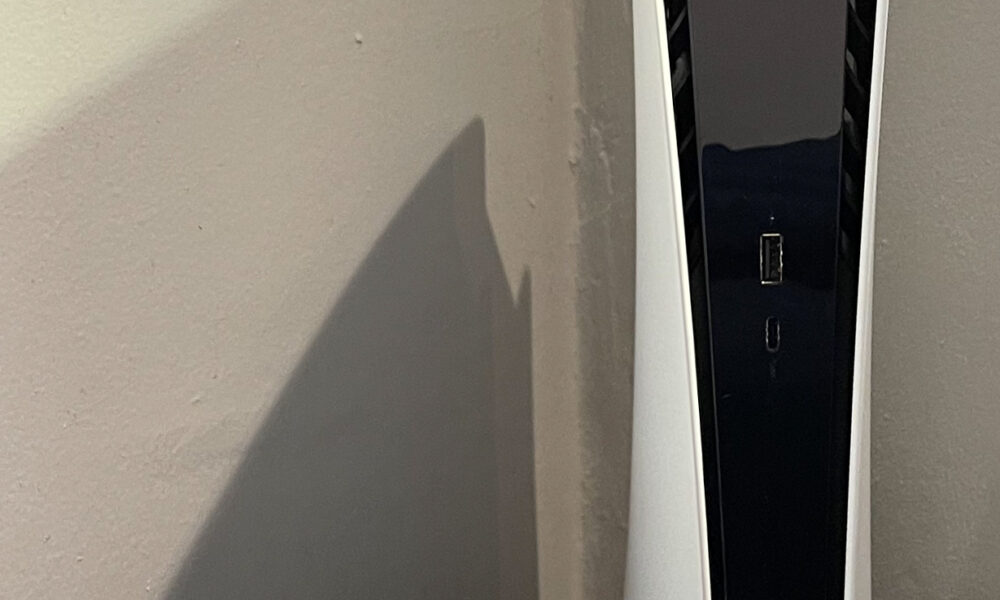 How to Clean PS5 Safely: Dust, Vents and What Not to Open PlayStation 5 Digital Edition console with a DualSense controller, showing exterior surfaces for dust care