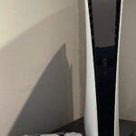 PlayStation 5 Digital Edition console with a DualSense controller, showing exterior surfaces for dust care