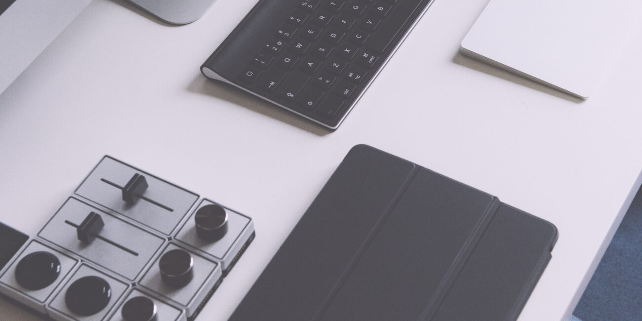 Real desk with an Apple iMac computer, smartphone, tablet and accessories illustrating Mac screenshot shortcuts
